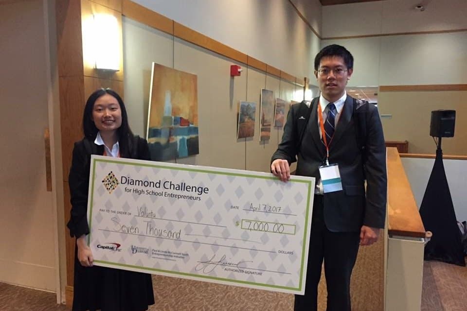 Amy and Jack holding an oversized seven-thousand-dollar cheque from the Diamond Challenge.